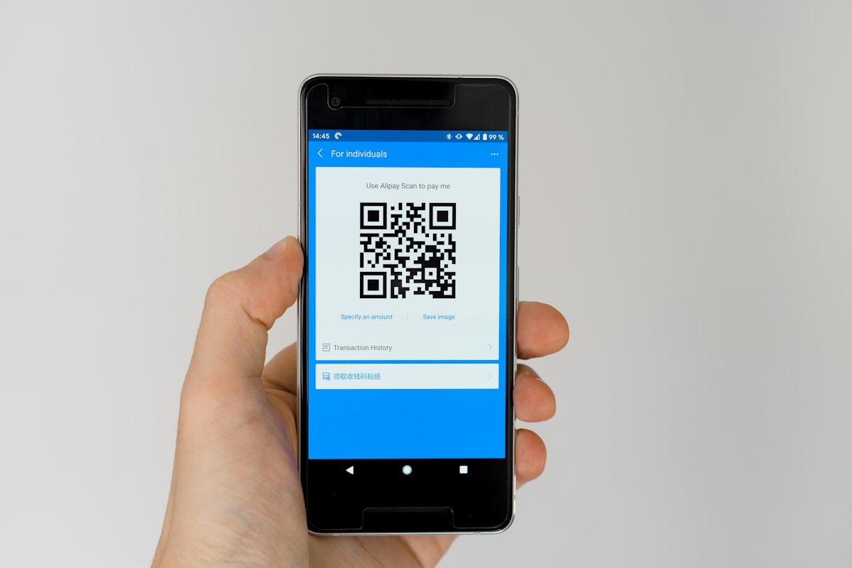 Osoba skenující QR kód chytrým telefonem